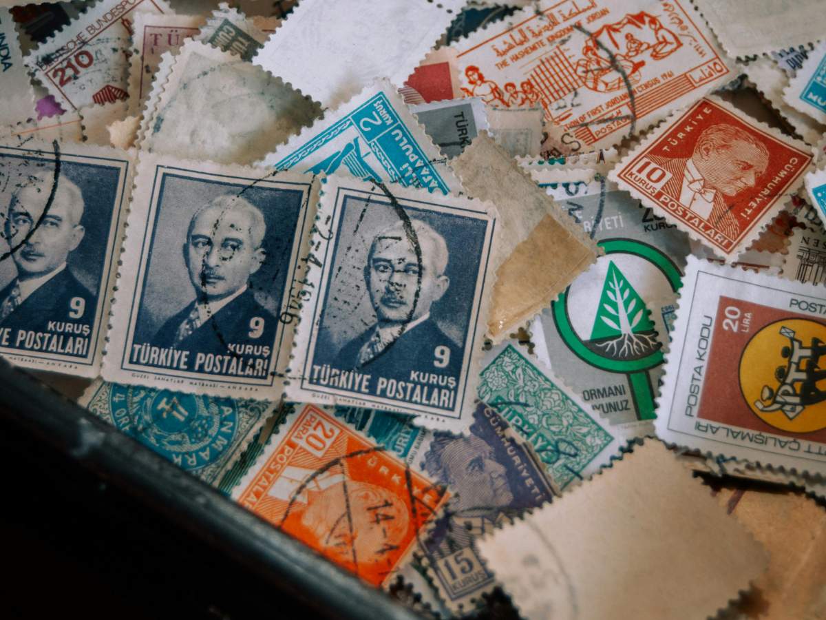 American Flag Forever stamps pane with official postal markings on lavender catalogs.